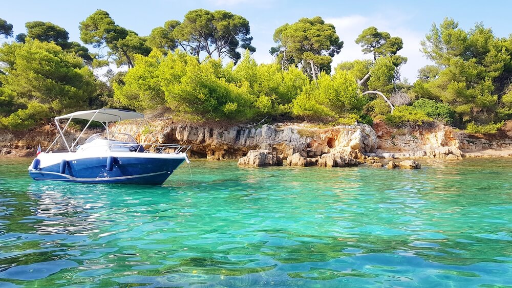 The 15 Prettiest Islands To Visit In France 8 Boat and landscape in the Sainte Marguerite island, Lerins islands, South of France (1)