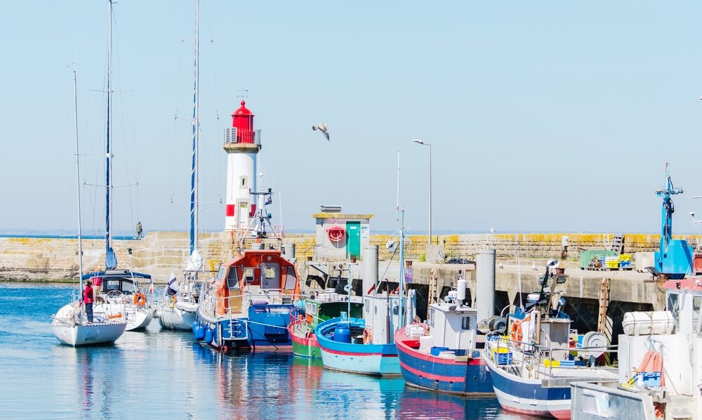 The 15 Prettiest Islands To Visit In France 11 Brittany, ile de Groix, harbor Port-Tudy, red lighthouse and boats (1)