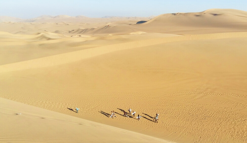 People on the dunes in Huacachina